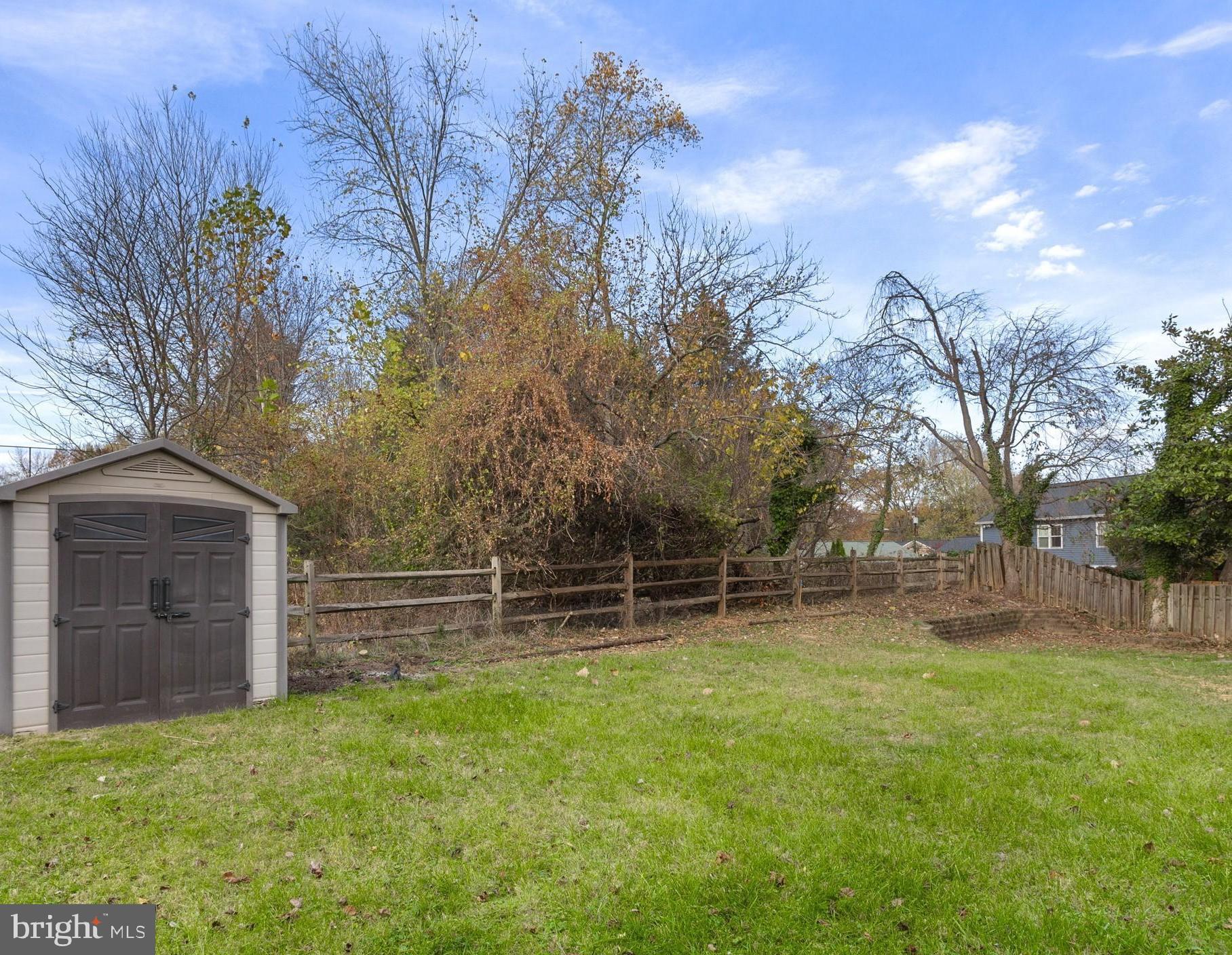 8403 Harker Drive Potomac, MD 20854 - Photo 32 of 33 a backyard of a house with lots of green space and wooden fence