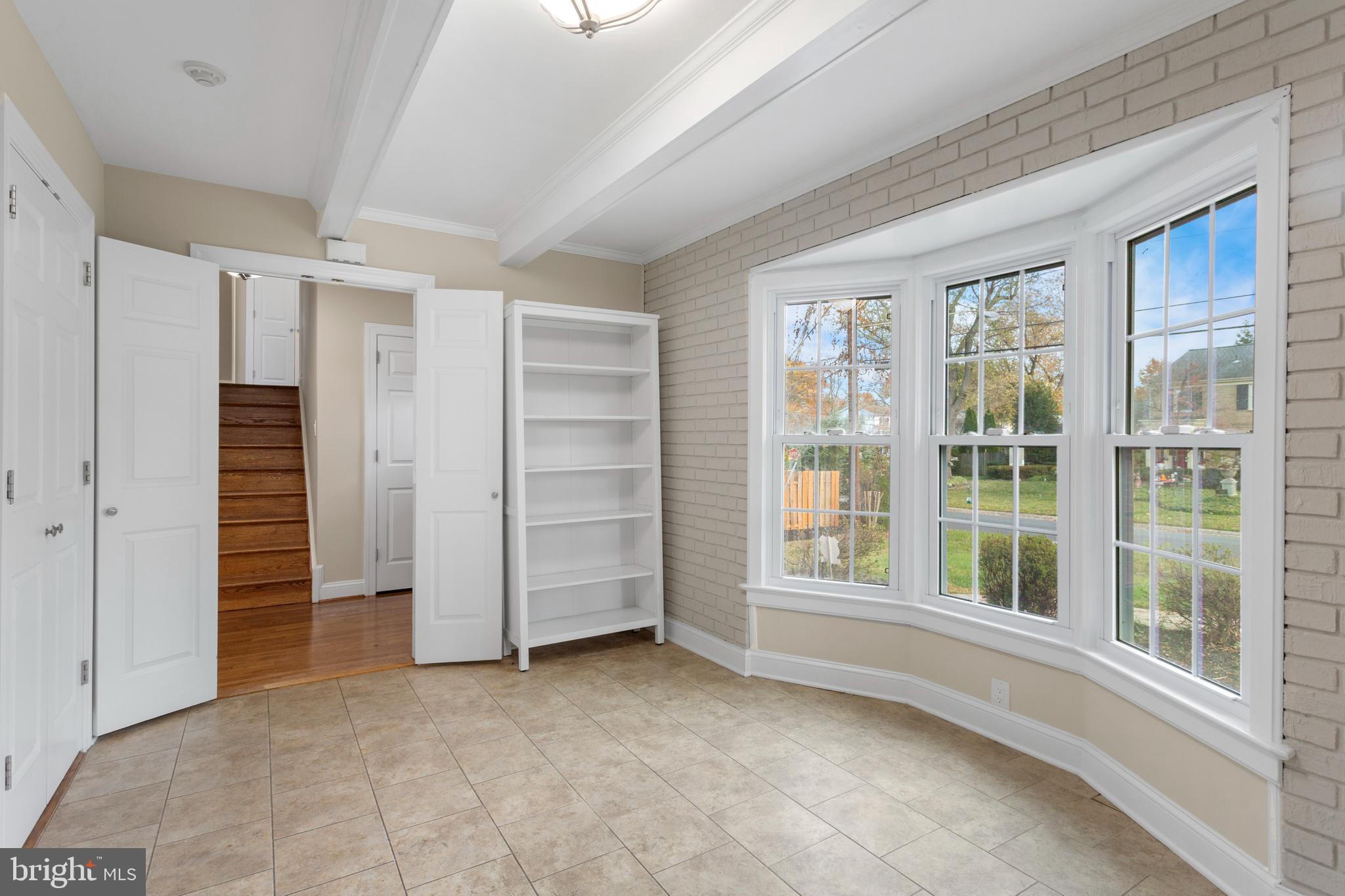 8403 Harker Drive Potomac, MD 20854 - Photo 6 of 33 an empty room with a fireplace and cabinet