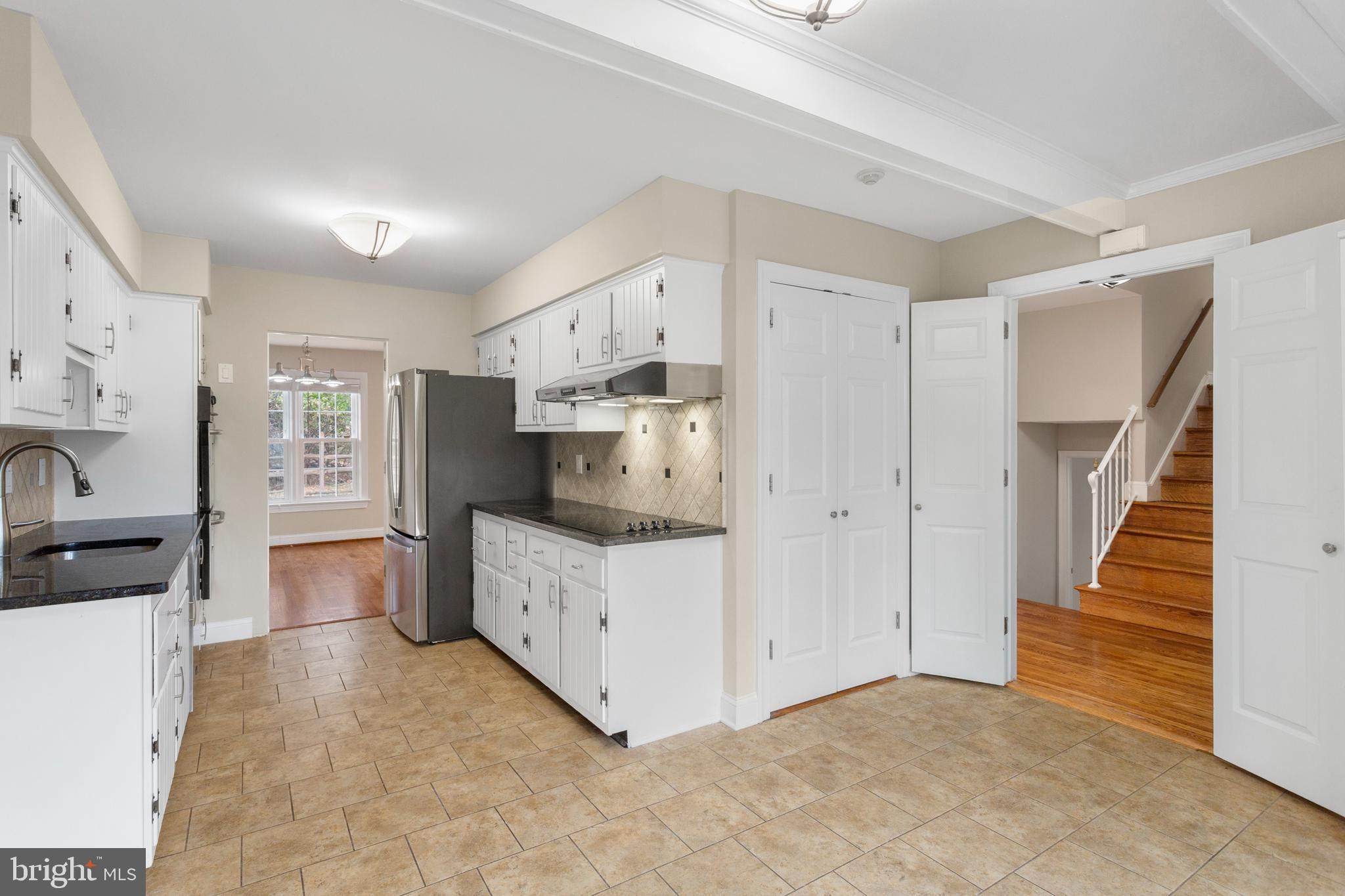8403 Harker Drive Potomac, MD 20854 - Photo 8 of 33 a large white kitchen with a stove a sink dishwasher and a refrigerator