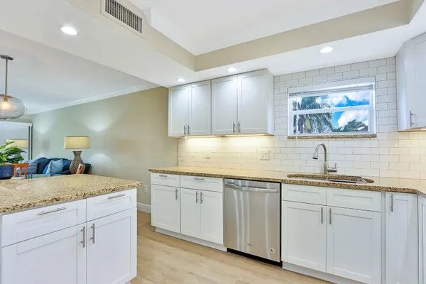 a view of a sink and cabinets