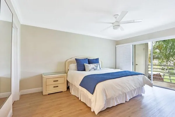a bedroom with a bed and large window