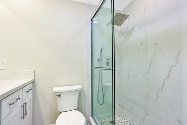 a bathroom with a toilet a sink and shower