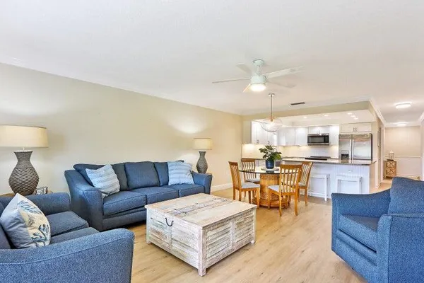 a living room with furniture and kitchen view