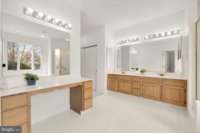 a large bathroom with a large tub and sink