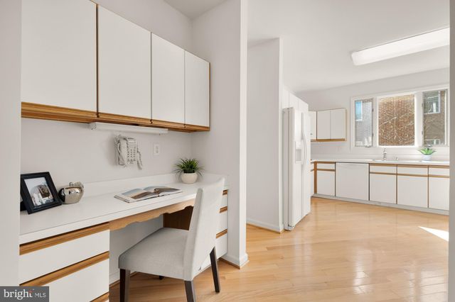 a kitchen with stainless steel appliances a sink a stove a refrigerator and cabinets