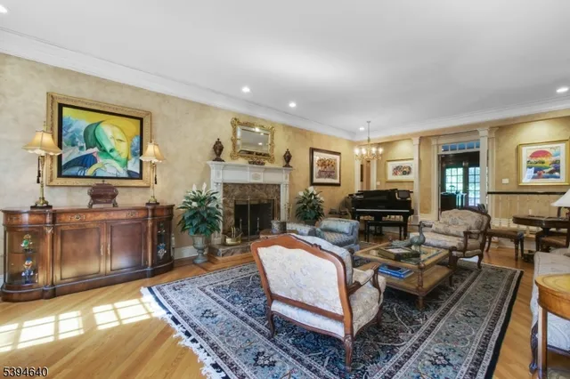 a view of a dining room with furniture a chandelier and wooden floor