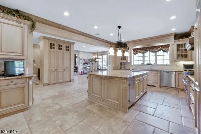 a view of a dining room with furniture and chandelier