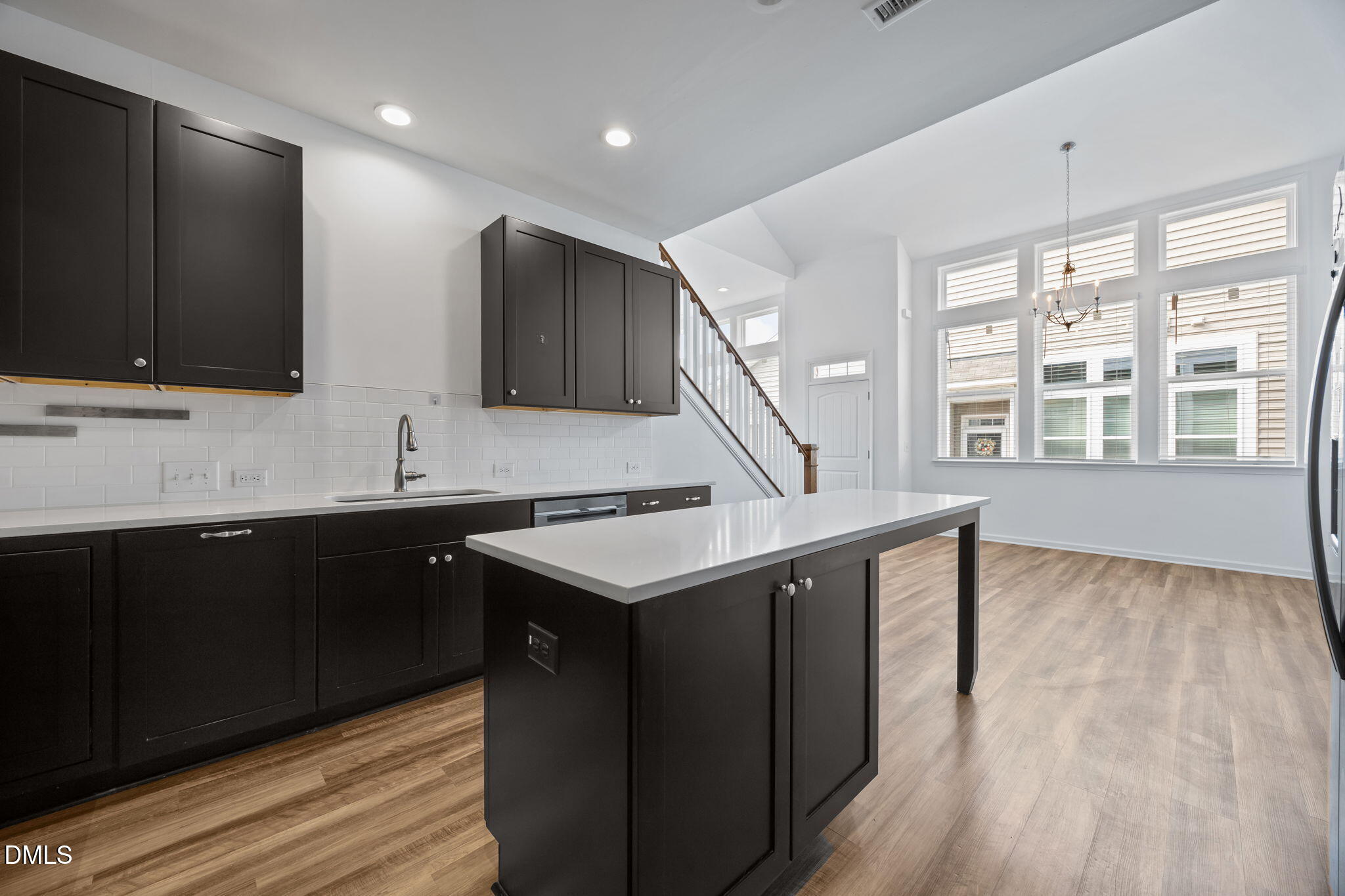 902 Talbot Place Durham, NC 27703 - Photo 16 of 49 a kitchen with stainless steel appliances granite countertop a sink a stove and a wooden floors