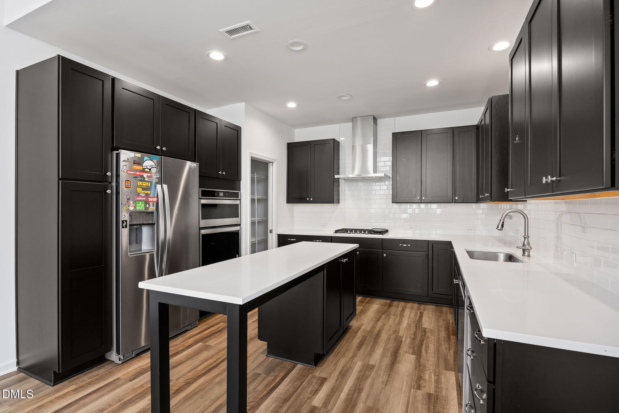 902 Talbot Place Durham, NC 27703 - Photo 10 of 49 a kitchen with stainless steel appliances granite countertop a refrigerator a sink and wooden cabinets