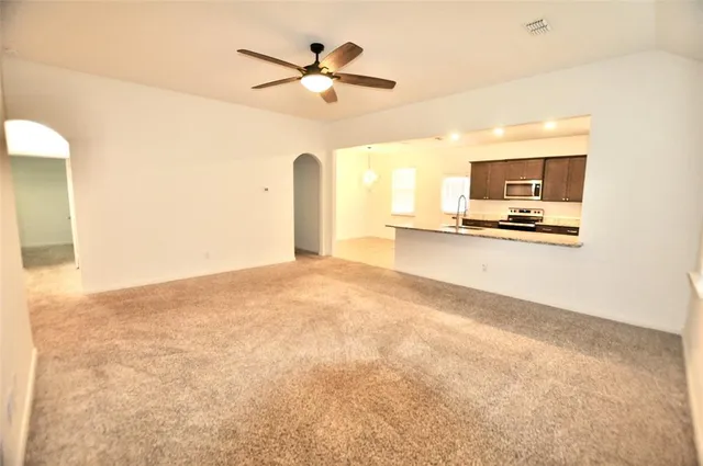 a view of a livingroom with a furniture and a ceiling fan