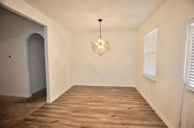 a view of a room with wooden floor and windows