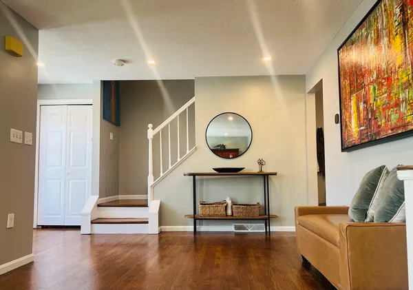 a living room with furniture and a wooden floor