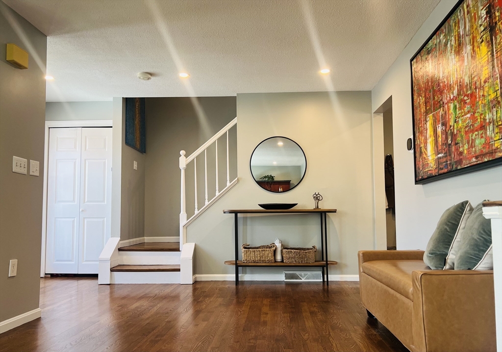 35 Pearl Street, Unit 35 Randolph, MA 02368 - Photo 1 of 31 a living room with furniture and a wooden floor