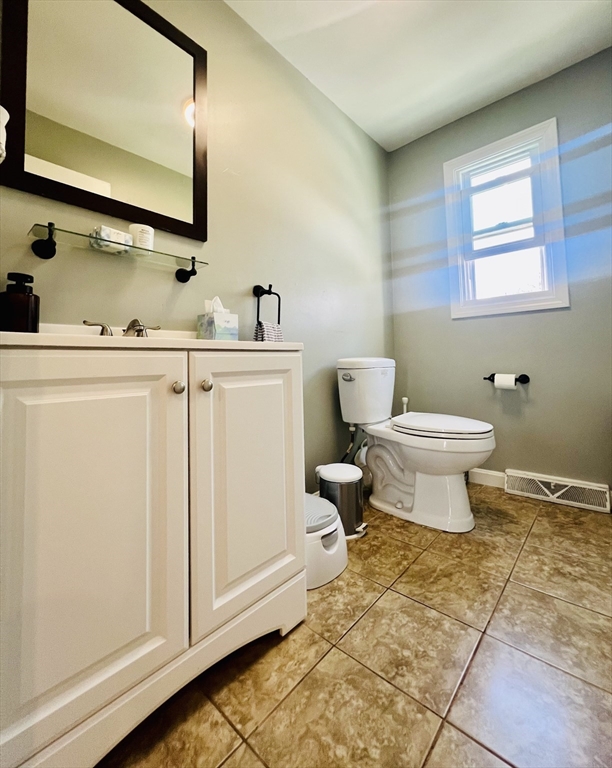 35 Pearl Street, Unit 35 Randolph, MA 02368 - Photo 14 of 31 a bathroom with a sink toilet and mirror