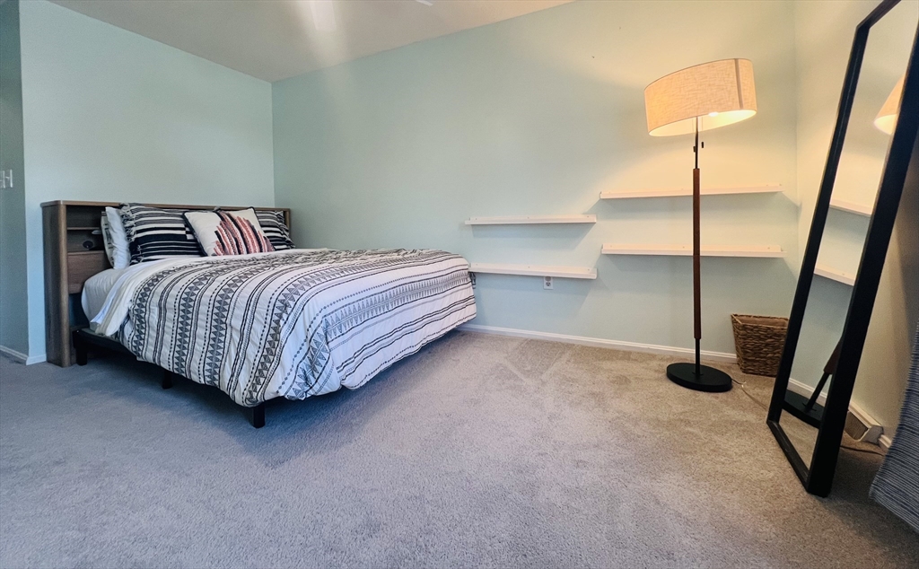 35 Pearl Street, Unit 35 Randolph, MA 02368 - Photo 20 of 31 a spacious bedroom with a bed and a lamp