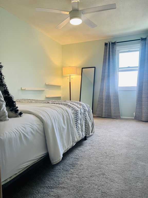 35 Pearl Street, Unit 35 Randolph, MA 02368 - Photo 21 of 31 a bedroom with a bed and lamp