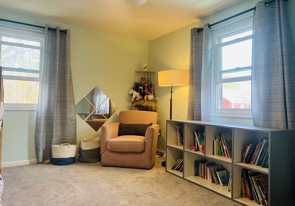 35 Pearl Street, Unit 35 Randolph, MA 02368 - Photo 23 of 31 a living room with furniture and a book shelf