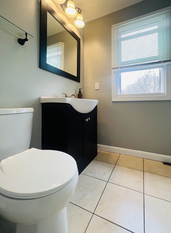 35 Pearl Street, Unit 35 Randolph, MA 02368 - Photo 29 of 31 a bathroom with a sink vanity mirror and toilet