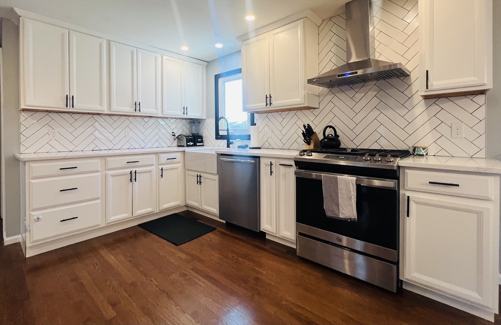 35 Pearl Street, Unit 35 Randolph, MA 02368 - Photo 10 of 31 a kitchen with stainless steel appliances granite countertop a stove and white cabinets