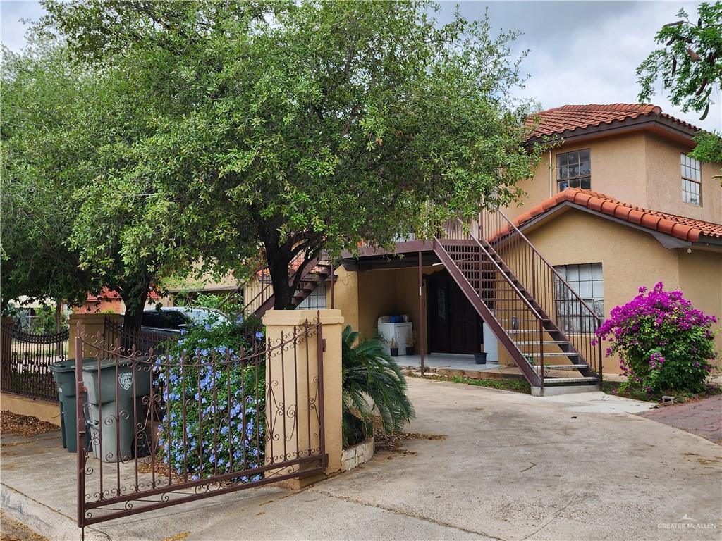 933 East 4th Street Roma, TX 78584 - Photo 15 of 15 a yellow house with trees in front of it