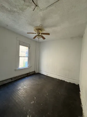 a large kitchen with kitchen island granite countertop a sink and a stove top oven