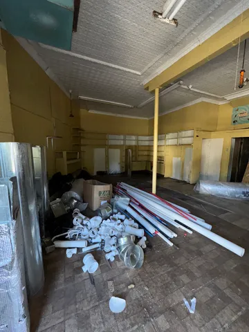 a view of a porch with a table and chairs