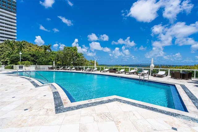 a balcony with wooden floor and outdoor seating