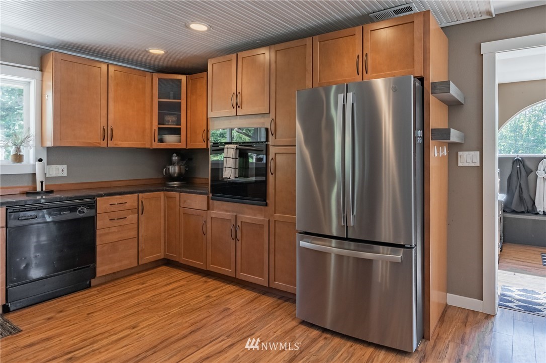 5202 Reese Hill Road Sumas, WA 98295 - Photo 8 of 39 a kitchen with a refrigerator stainless steel appliances wooden floor and cabinets