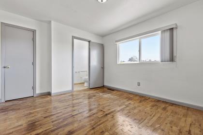 1699 Highland Street Seaside, CA 93955 - Photo 19 of 24 a view of an empty room with wooden floor and a window