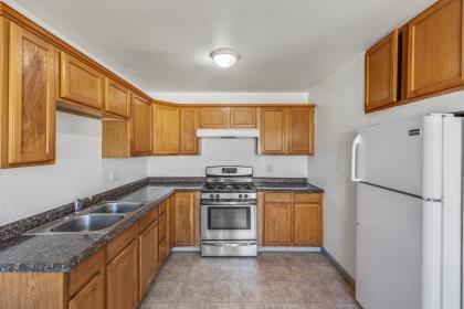 1699 Highland Street Seaside, CA 93955 - Photo 4 of 24 a kitchen with stainless steel appliances granite countertop a stove a refrigerator and a sink
