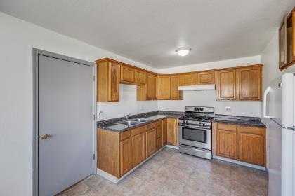 1699 Highland Street Seaside, CA 93955 - Photo 5 of 24 a kitchen with stainless steel appliances granite countertop a stove a sink and a refrigerator