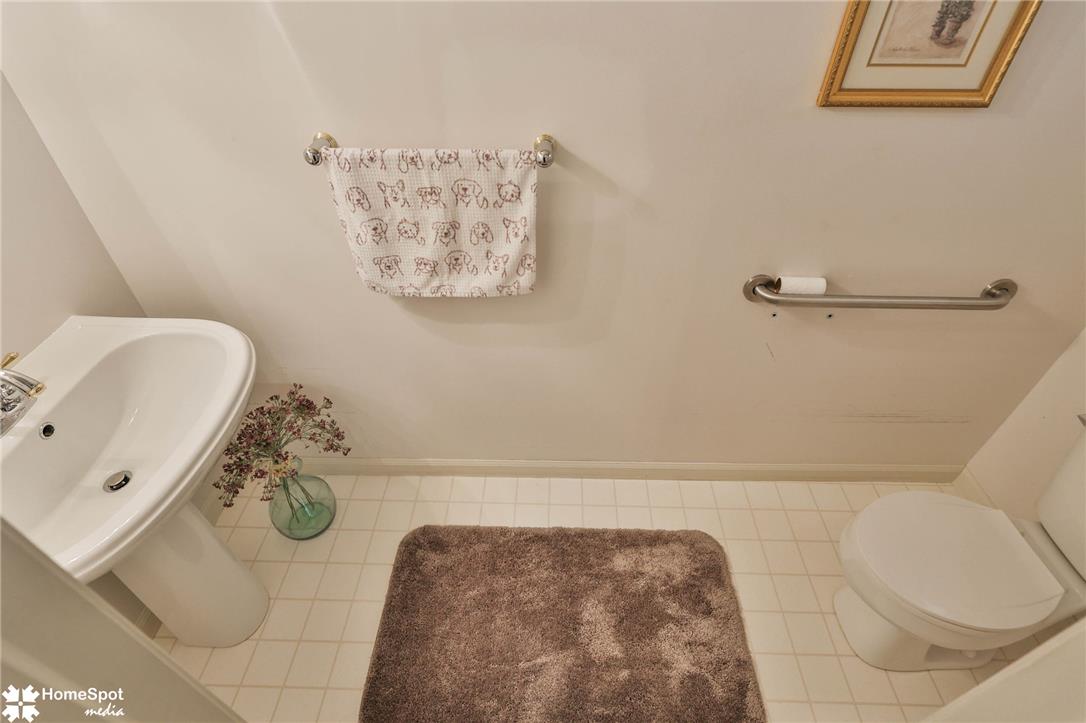 507 Howertown Road Northampton, PA 18067 - Photo 4 of 46 White pedestal sink and toilet complement the tile flooring in this powder room.