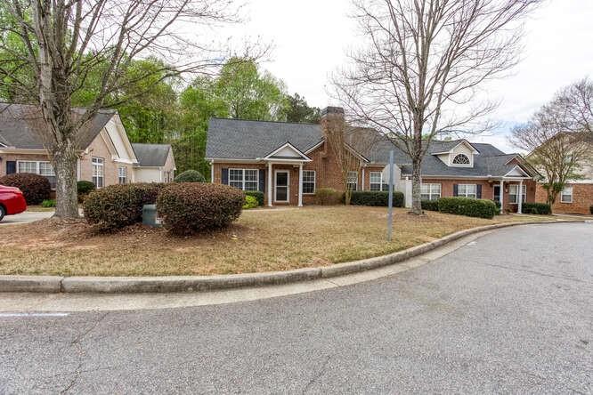 3402 Raes Creek Road, Unit 27 Marietta, GA 30008 - Photo 4 of 32 a front view of a house with a yard