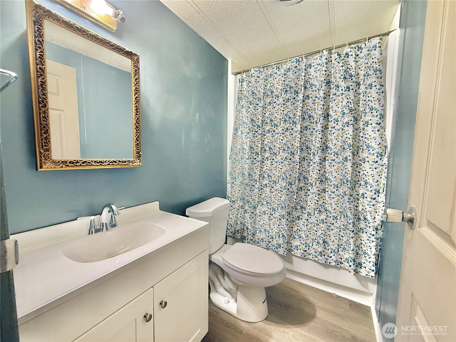 3001 South 288th Street, Unit 343 Federal Way, WA 98003 - Photo 17 of 37 a bathroom with a sink a toilet and shower curtain