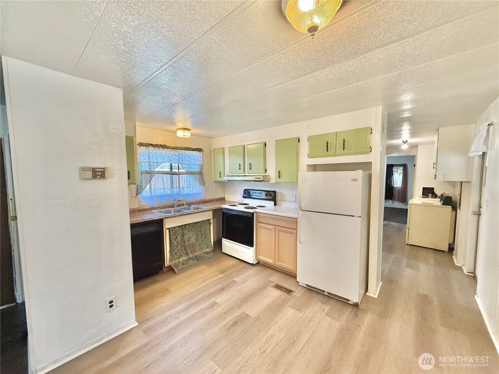 3001 South 288th Street, Unit 343 Federal Way, WA 98003 - Photo 5 of 37 a kitchen with refrigerator cabinets and wooden floor