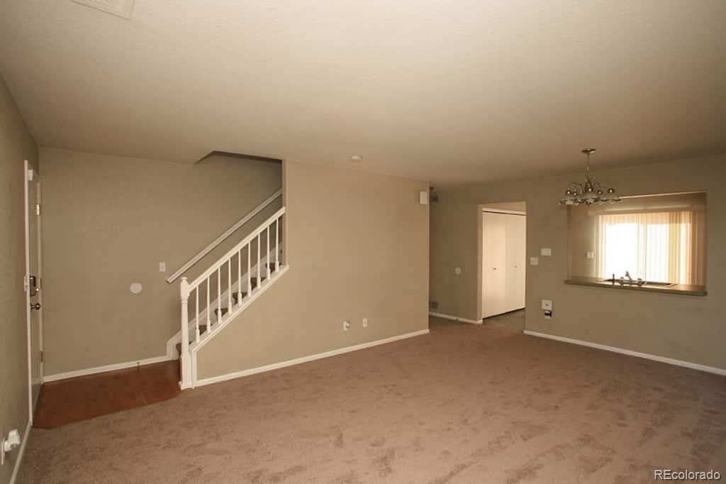 4067 Andes Way Denver, CO 80249 - Photo 3 of 4 a view of an empty room with stairs
