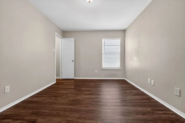 wooden floor in an empty room with a fireplace