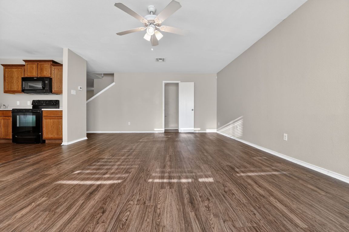 13205 Vizquel Loop Del Valle, TX 78617 - Photo 16 of 31 wooden floor in an empty room with a fireplace