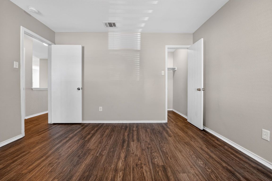 13205 Vizquel Loop Del Valle, TX 78617 - Photo 23 of 31 a view of an empty room with wooden floor