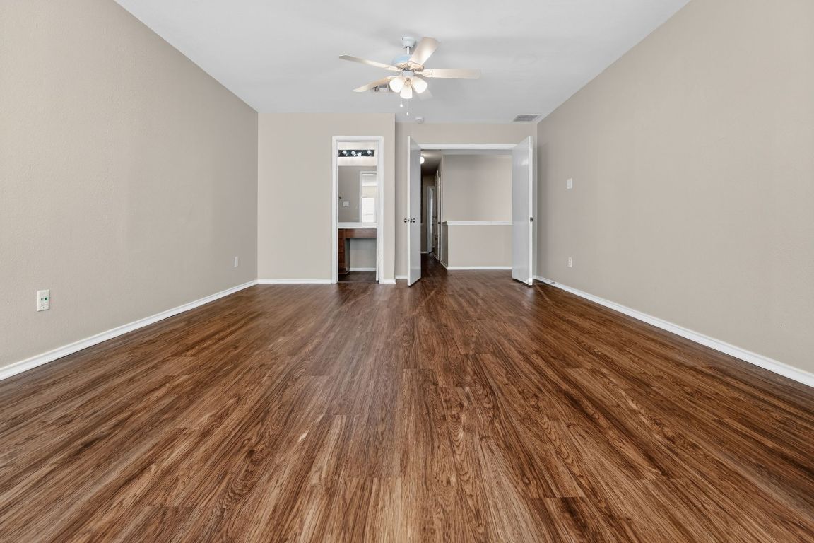 13205 Vizquel Loop Del Valle, TX 78617 - Photo 25 of 31 a view of empty room with wooden floor and ceiling fan