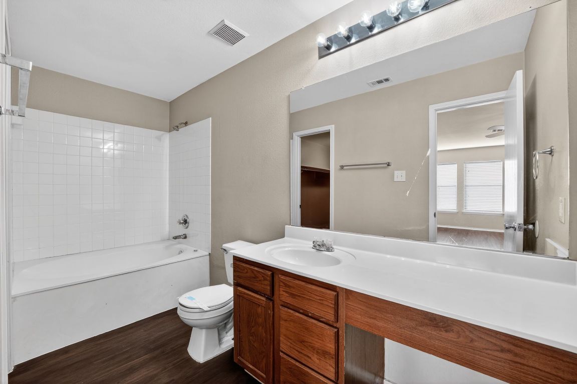 13205 Vizquel Loop Del Valle, TX 78617 - Photo 26 of 31 a bathroom with a sink a toilet and shower