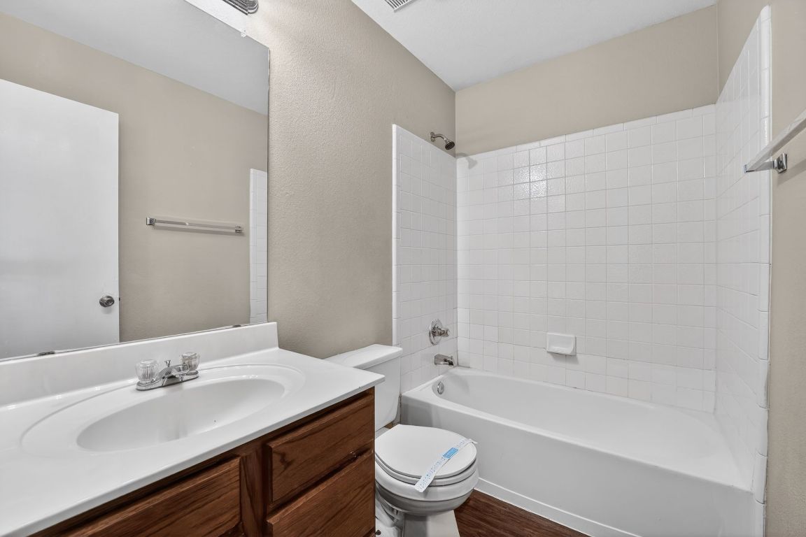 13205 Vizquel Loop Del Valle, TX 78617 - Photo 27 of 31 a bathroom with a granite countertop sink toilet and shower