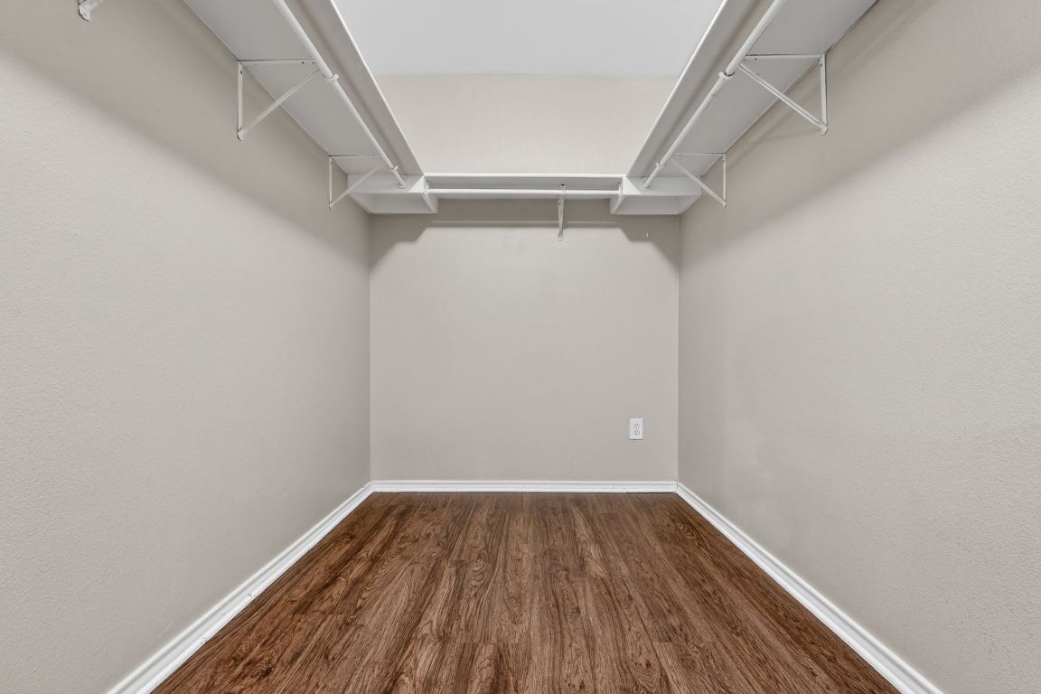 13205 Vizquel Loop Del Valle, TX 78617 - Photo 30 of 31 a view of walk in closet with wooden floor