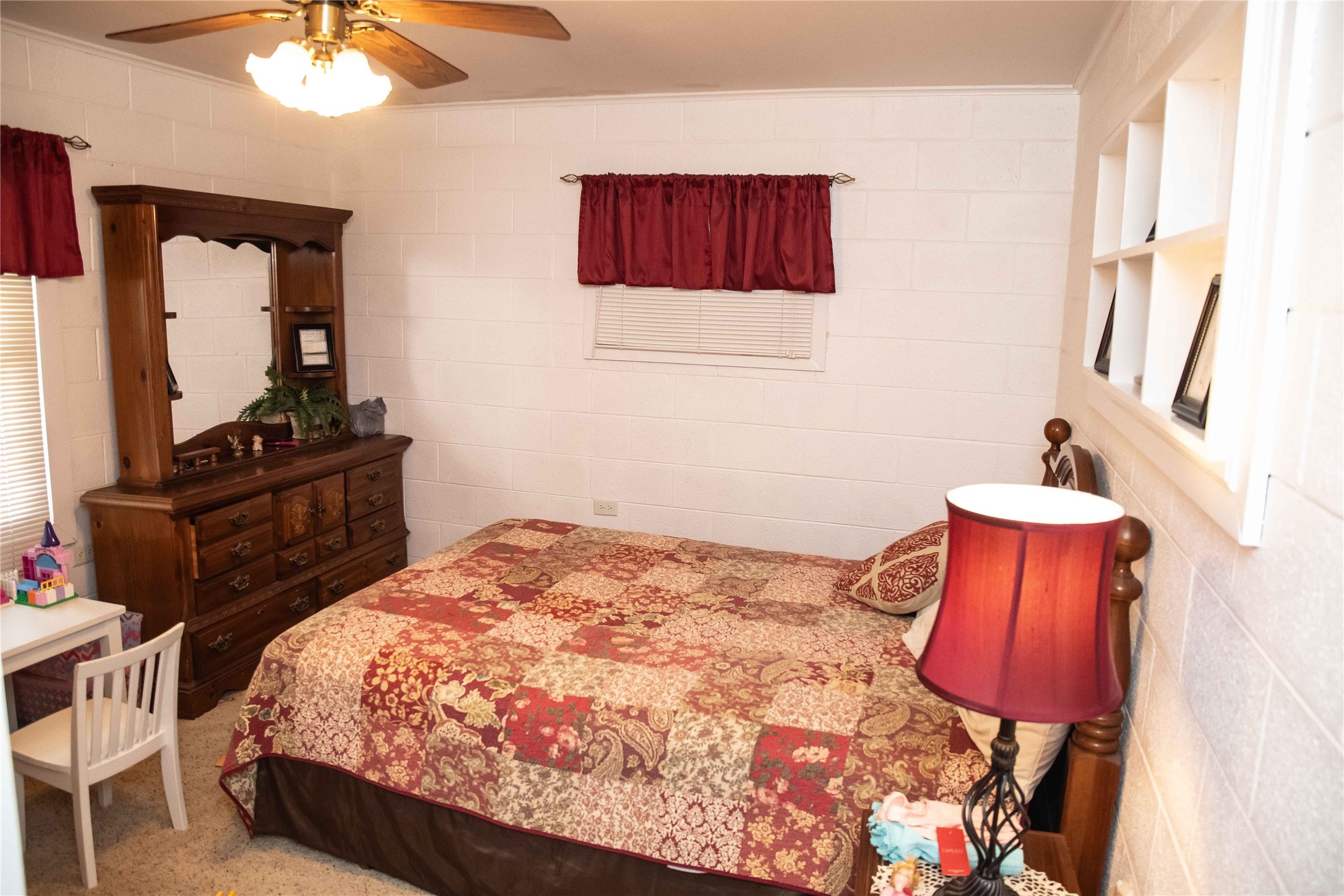 407 Rorem Avenue Palacios, TX 77465 - Photo 11 of 18 a bedroom with a bed and a lamp on dresser