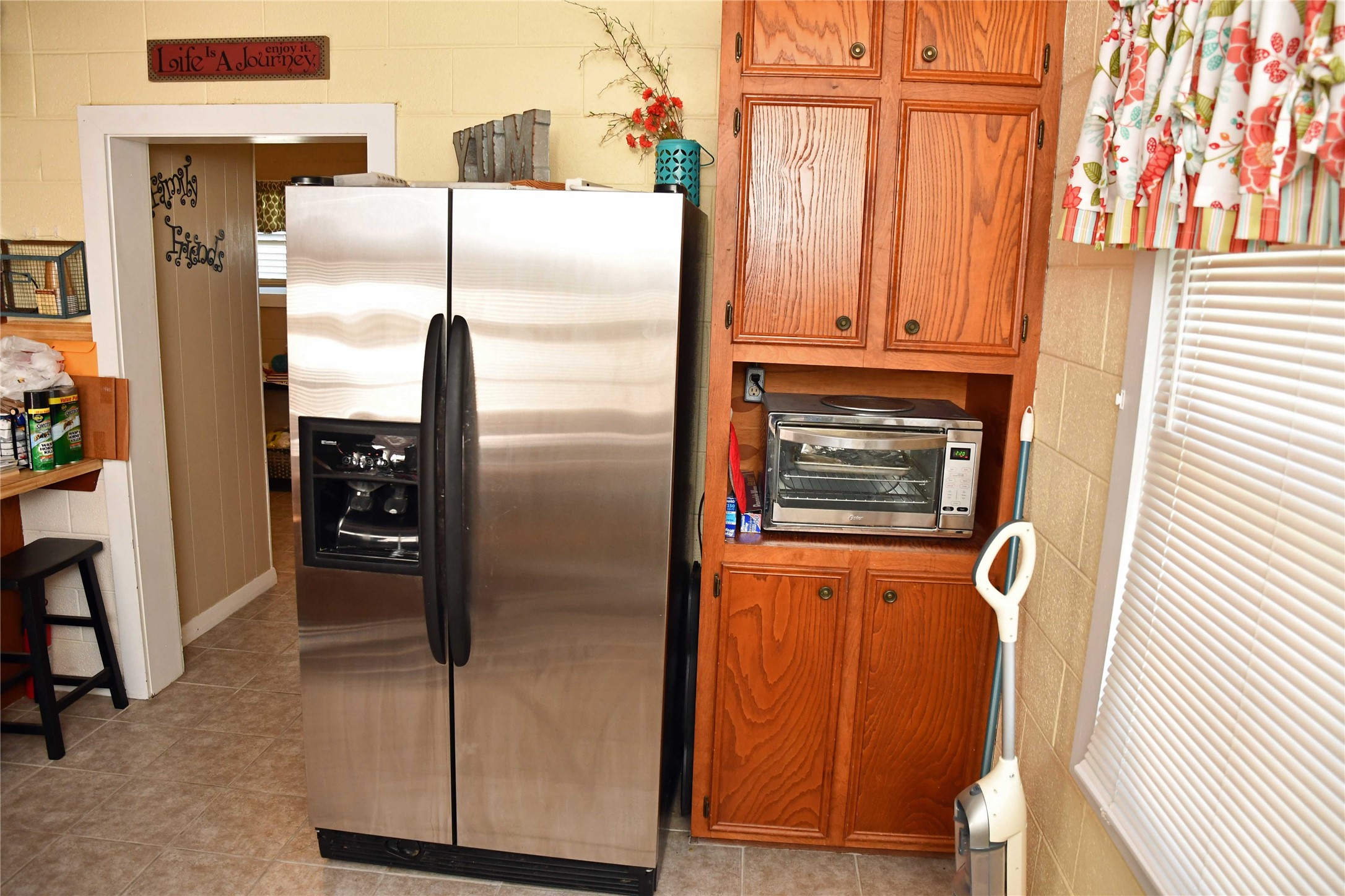 407 Rorem Avenue Palacios, TX 77465 - Photo 5 of 18 a close view of a refrigerator in kitchen and wooden floor