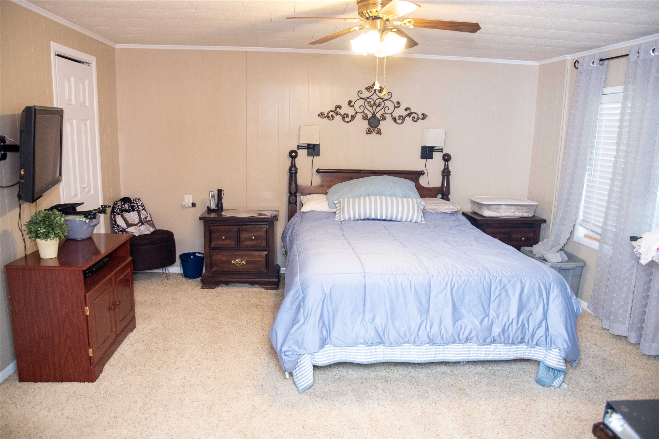 407 Rorem Avenue Palacios, TX 77465 - Photo 7 of 18 a bedroom with a bed and a chandelier