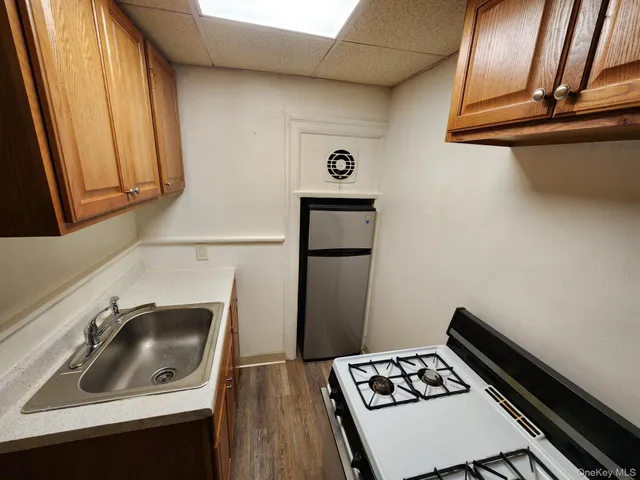 a kitchen with a sink and a stove top oven