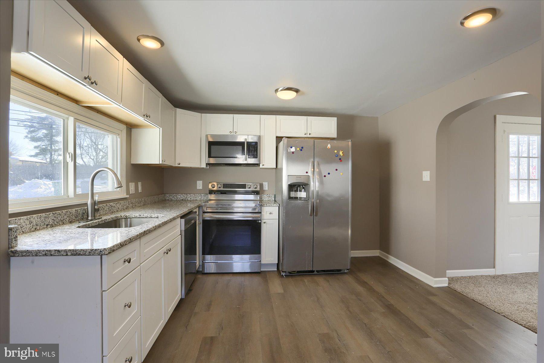 801 North Mountain Road Harrisburg, PA 17112 - Photo 8 of 32 a kitchen with a sink a refrigerator and a stove
