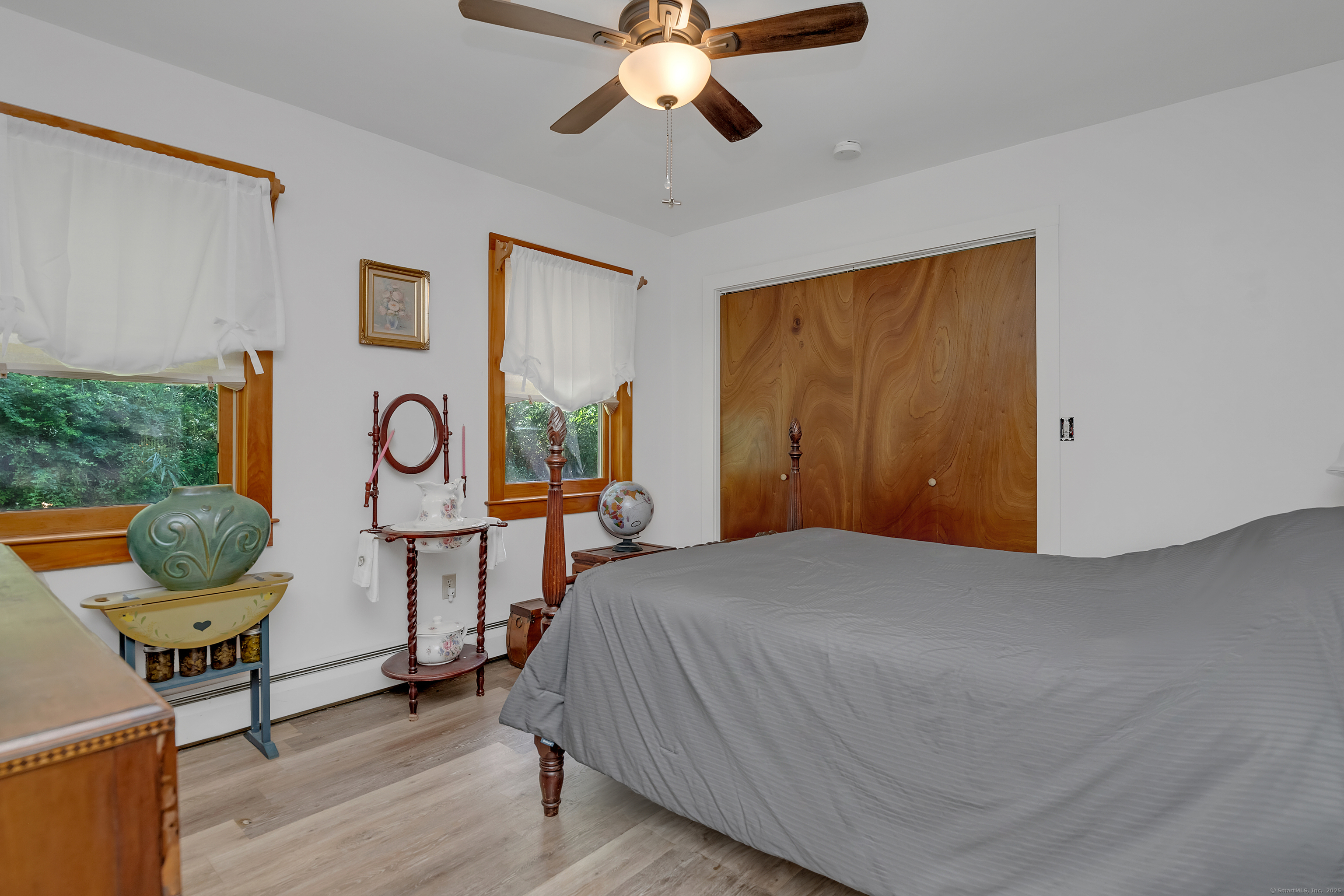 55 Mallory Road Roxbury, CT 06783 - Photo 16 of 34 a bedroom with a bed and a chandelier