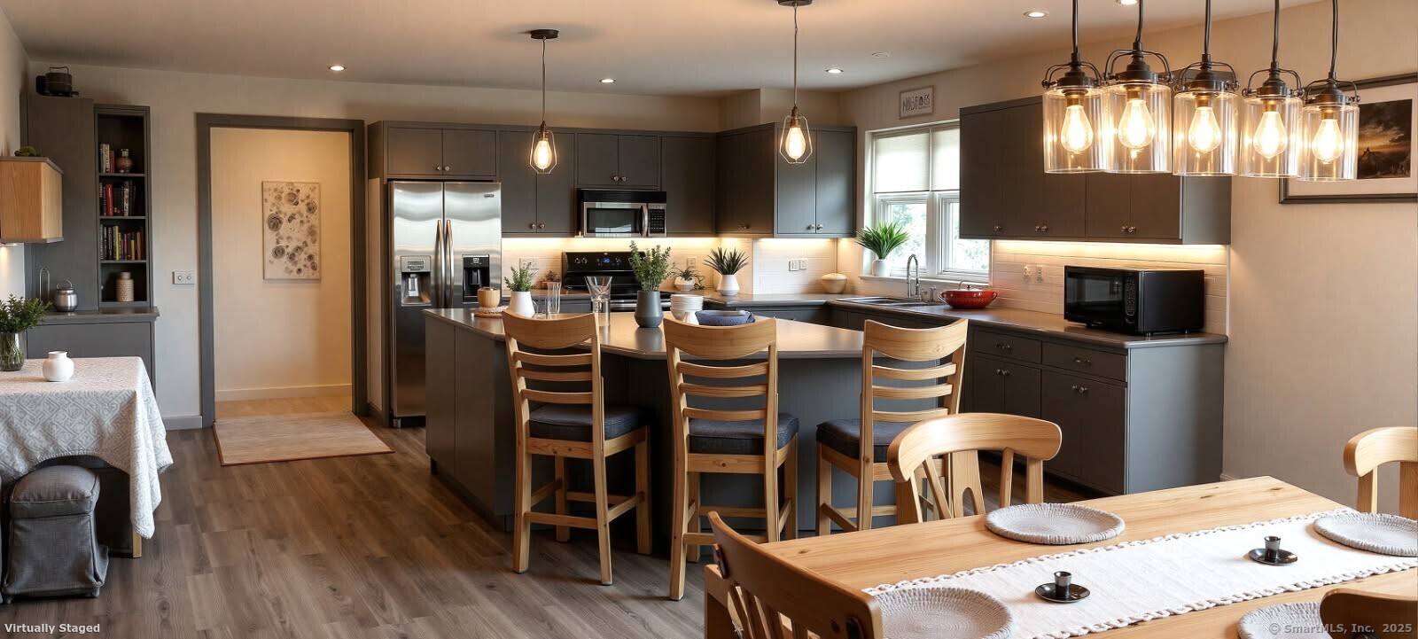 55 Mallory Road Roxbury, CT 06783 - Photo 18 of 34 a kitchen with stainless steel appliances kitchen island granite countertop a dining table chairs and wooden floor